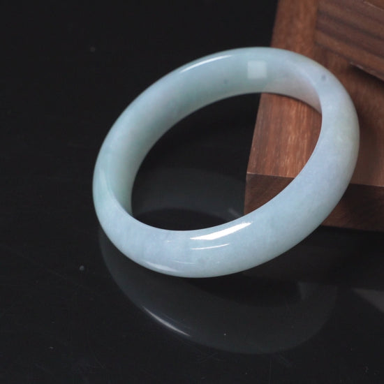 A pale frosty jadeite bangle.