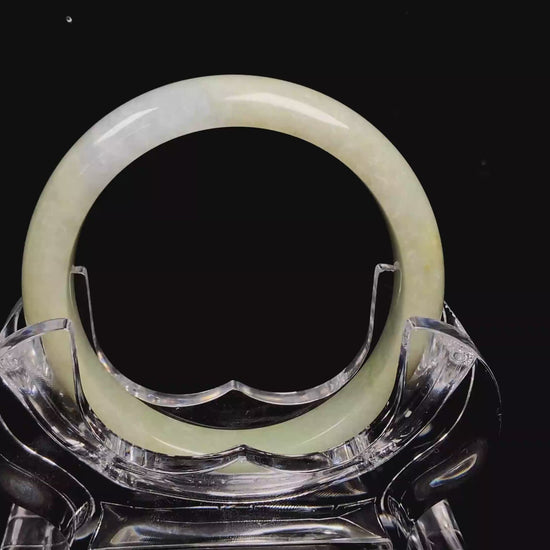 A golden glow spill jadeite bangle.