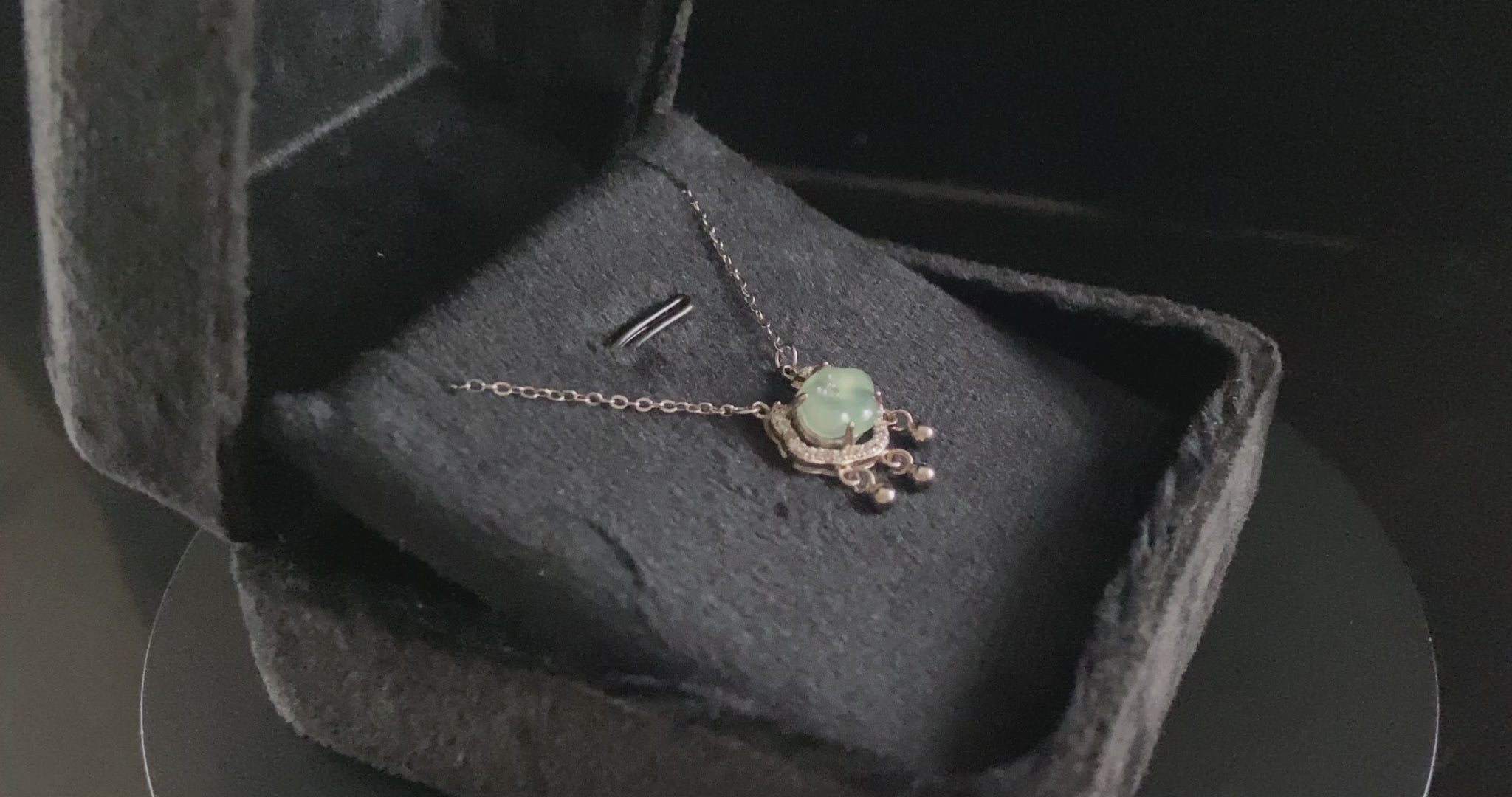 A ice green Ruyi chime jadeite pendant.