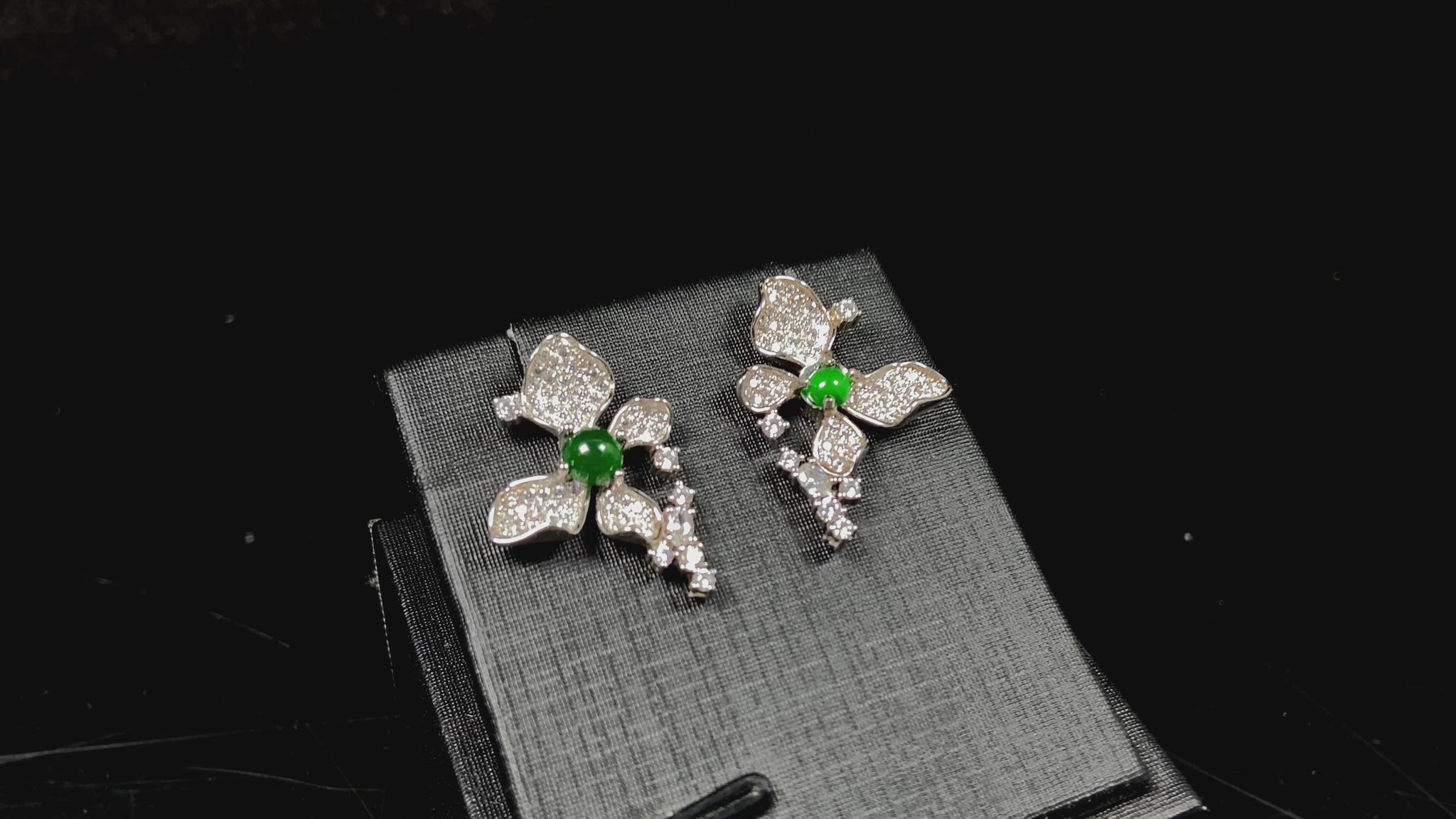A pair of sparkling petal green core jadeite earrings.