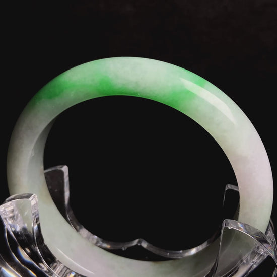A bright green cloud white jadeite bangle.