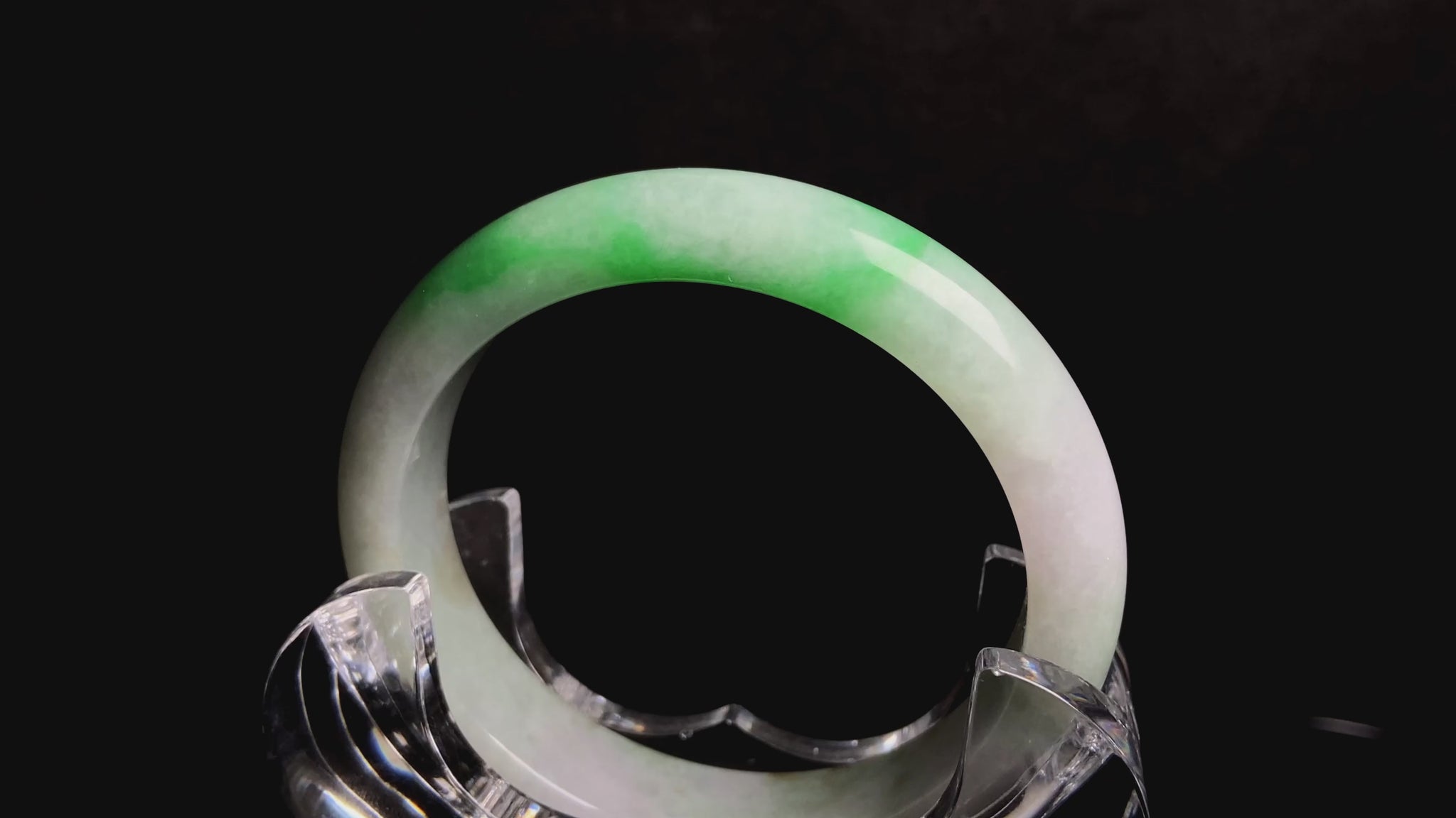 A bright green cloud white jadeite bangle.