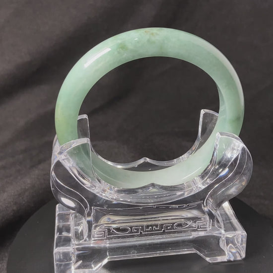 A white base mint green veil jadeite bangle.