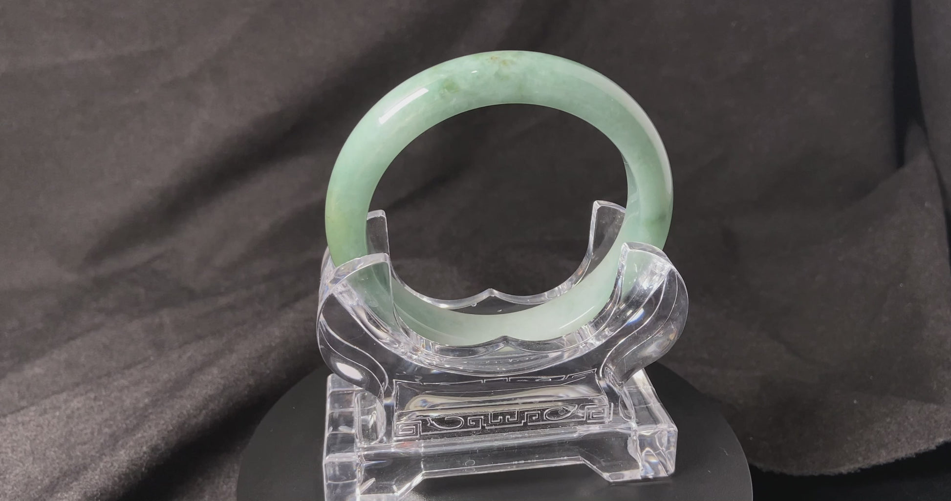 A white base mint green veil jadeite bangle.