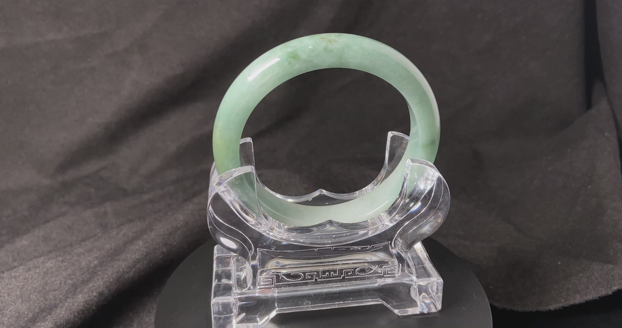 A white base mint green veil jadeite bangle.