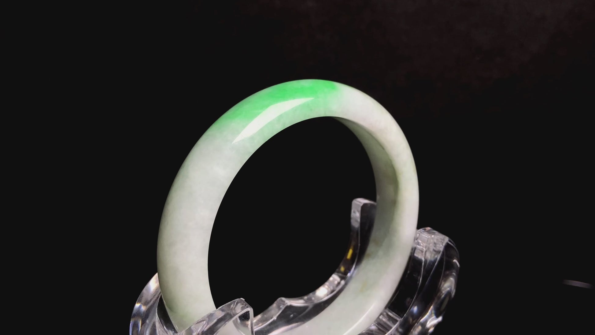A white base with sunlit green jadeite bangle.