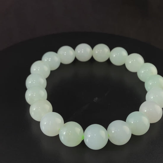 A milky pale green calm jadeite beads bracelet.