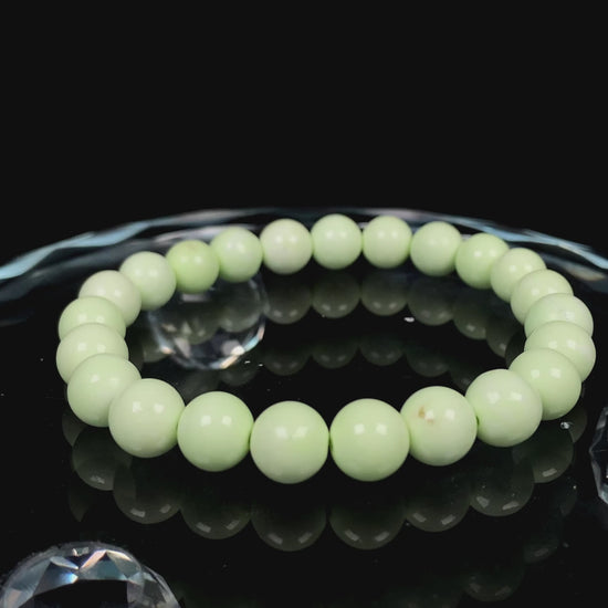 A turquoise green smooth bead ceramic beaded bracelet.