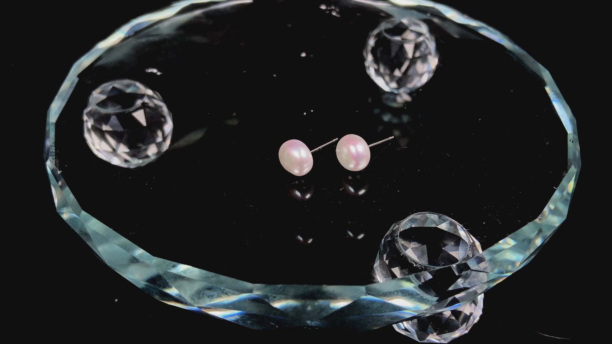 A pair of bloom pink glow pearl earrings.