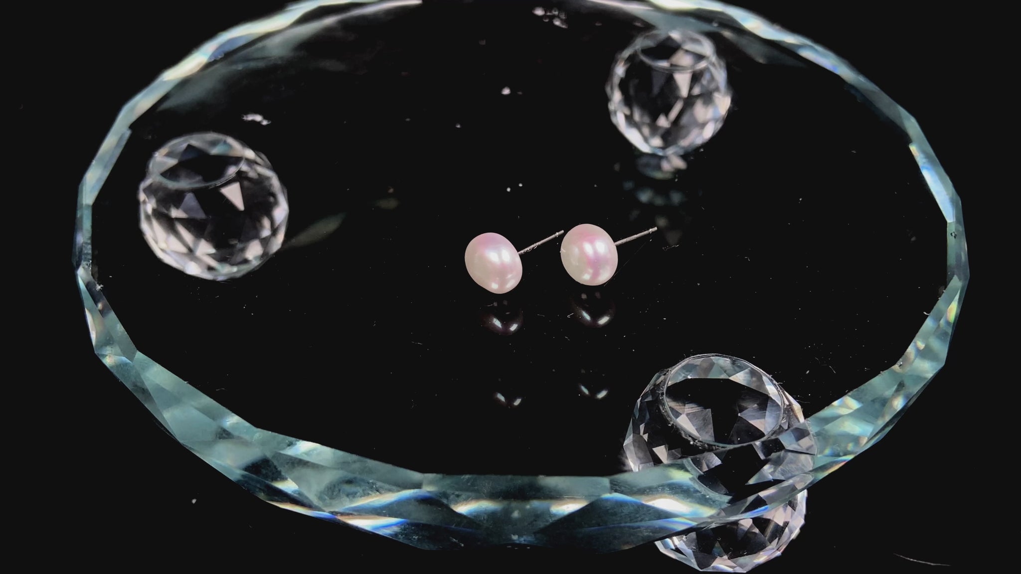 A pair of bloom pink glow pearl earrings.