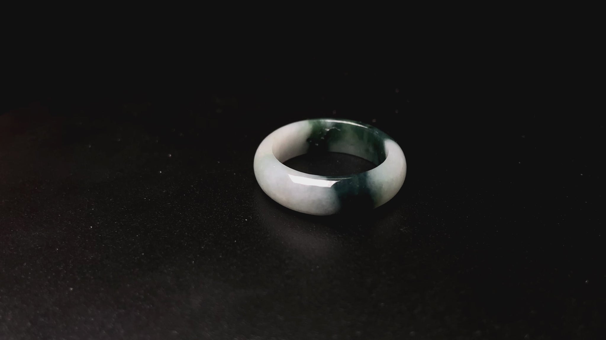 A ink green cloud jadeite ring.