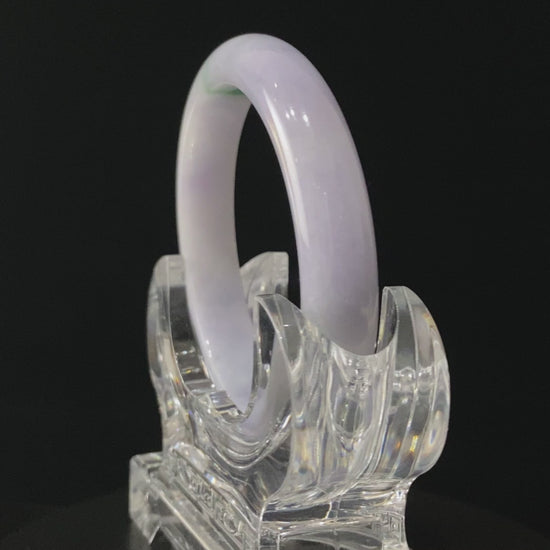 A lavender green streak jadeite bangle.