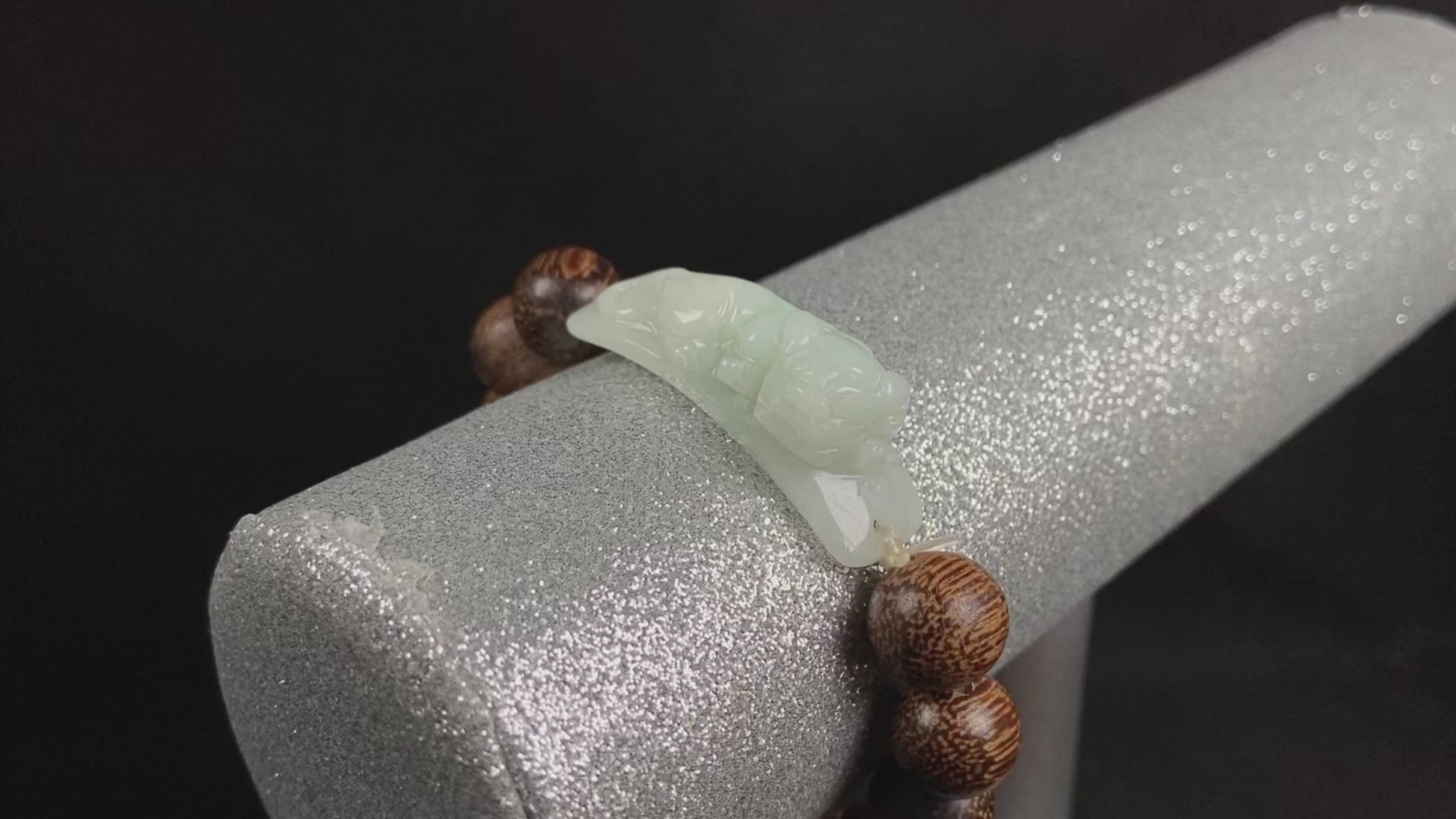 A white green Pixiu’s blessing jadeite agarwood bracelet.