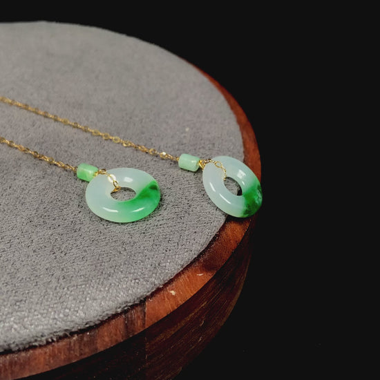 A white green donut jadeite earring.