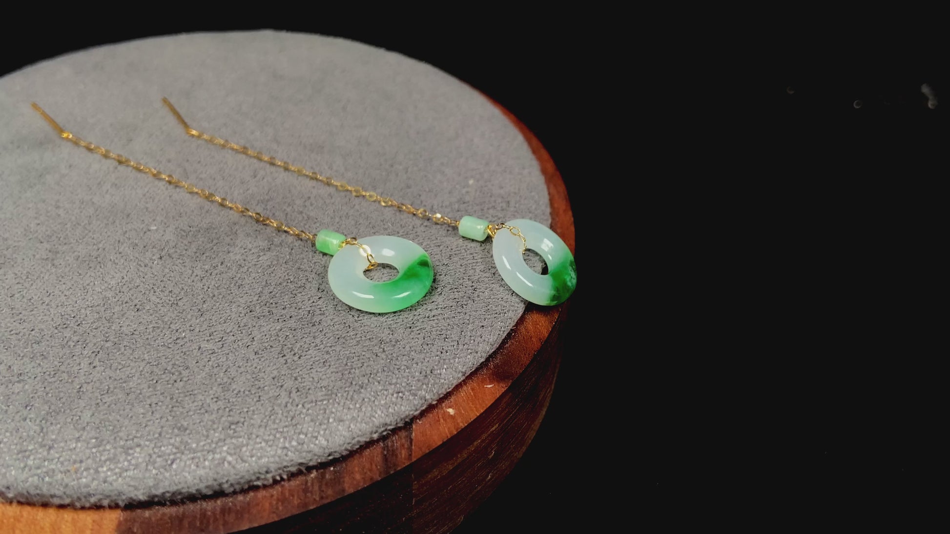 A white green donut jadeite earring.