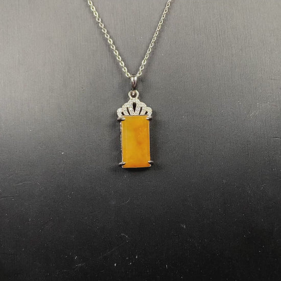 A amber glow of royal crown jadeite pendant.