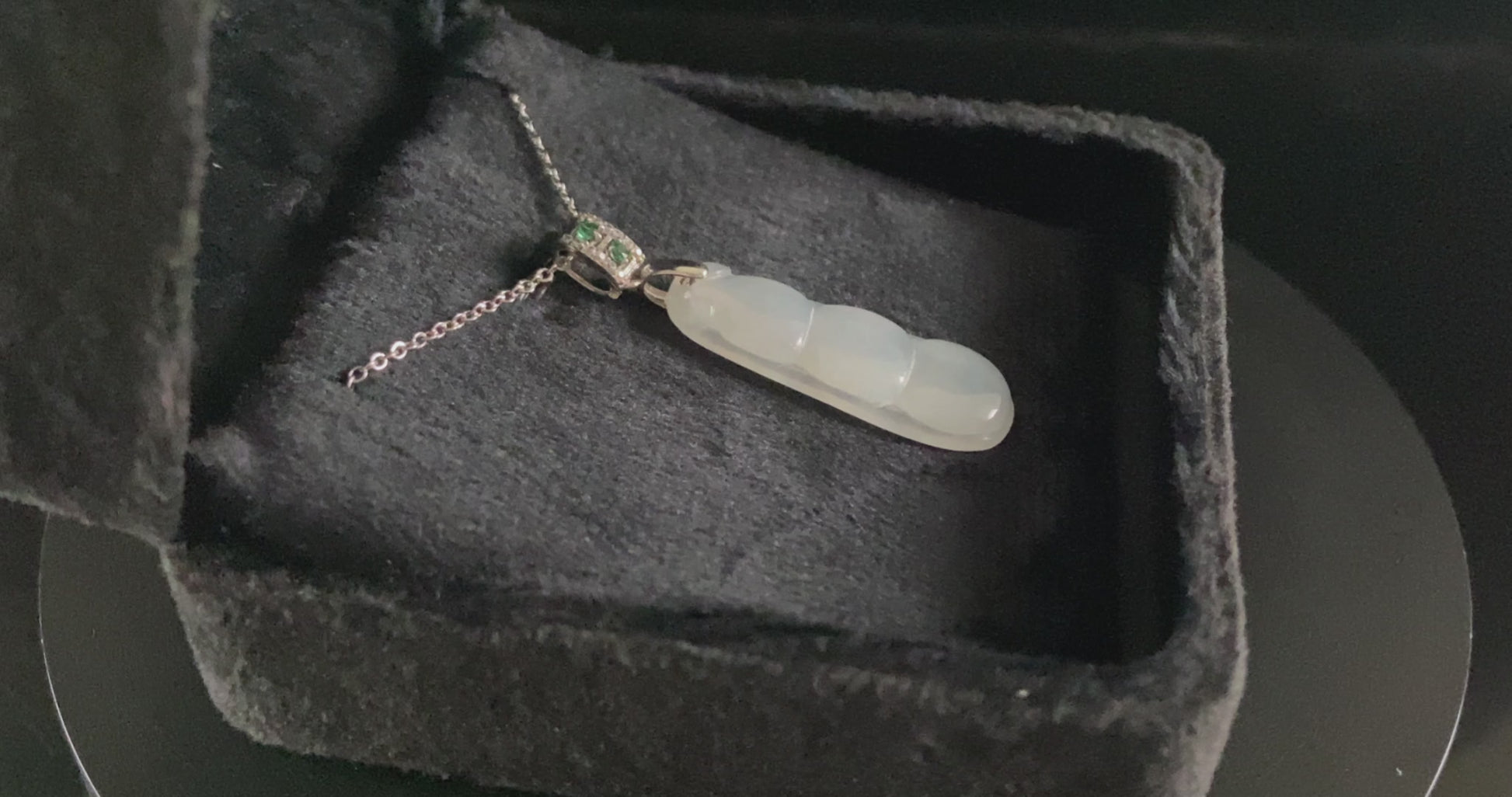A glacial green bean jadeite pendant.