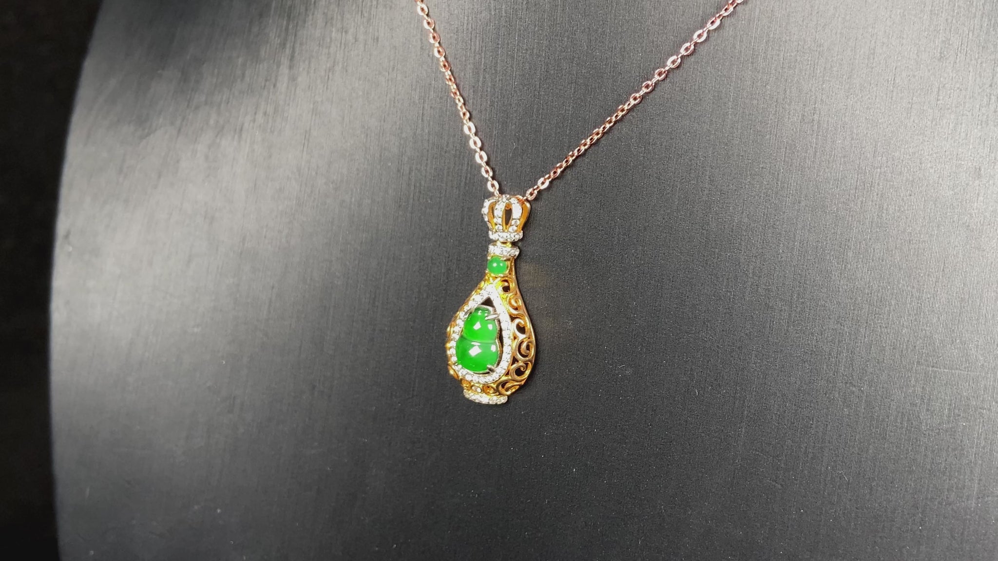 A rich green fortune gourd jadeite pendant.