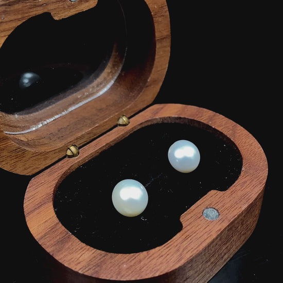 A pair of soft milky white shine pearl earrings.