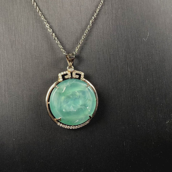 A jelly green twin fish jadeite pendant.