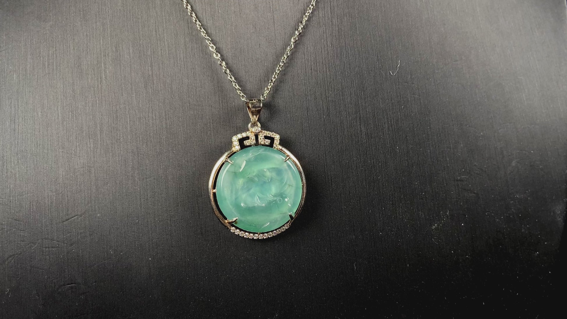 A jelly green twin fish jadeite pendant.