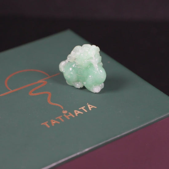 A luminous mint green Pixiu loose jadeite.