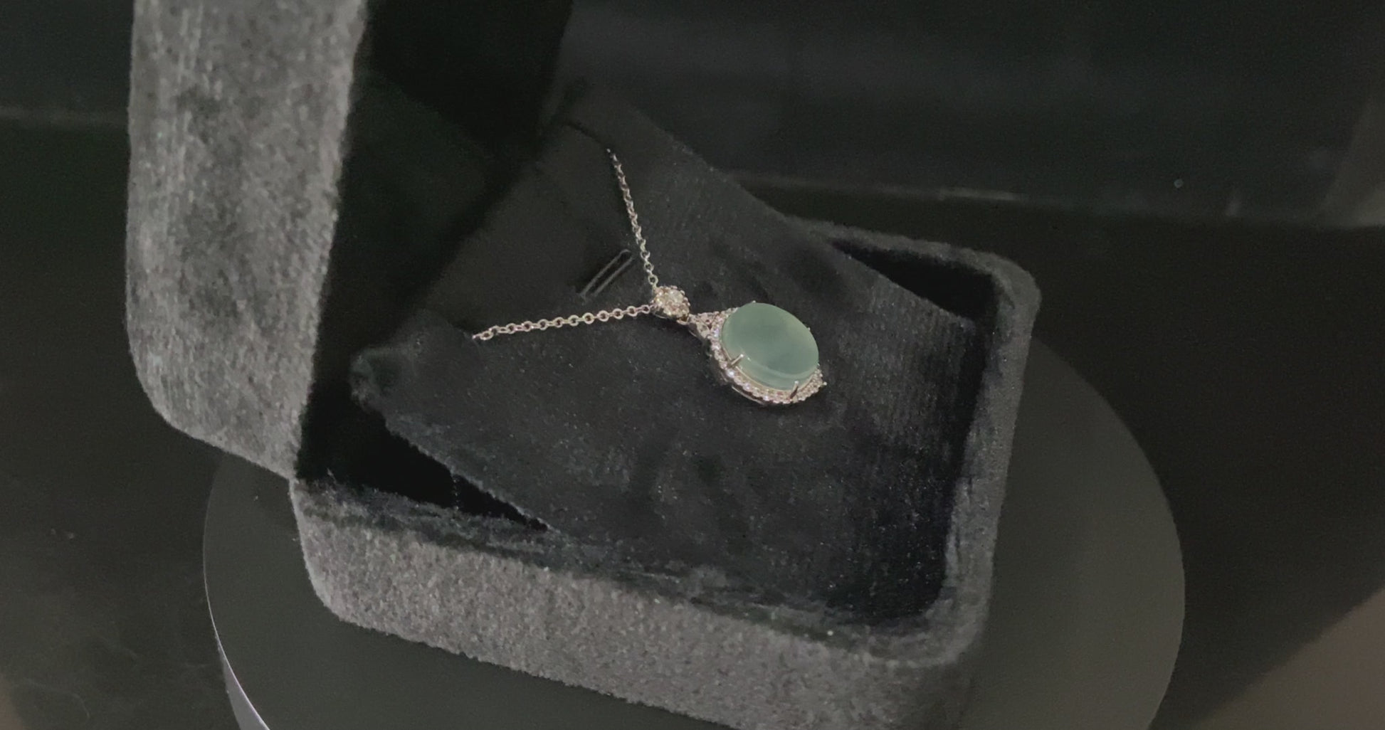A mint dew disk jadeite pendant.