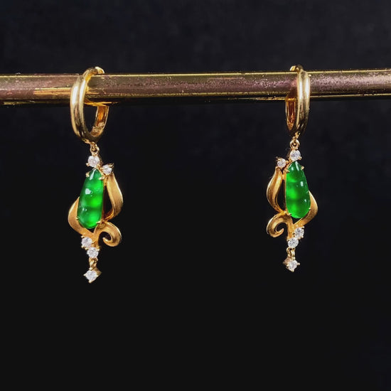 A pair of vivid green snap pea jadeite earrings.