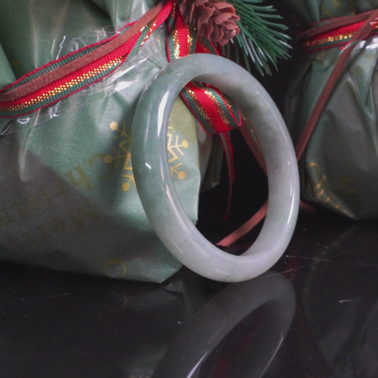 A mist green gentle luster jadeite bangle.