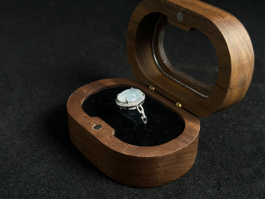 This elegant ring features an ice colored jade bead securely set with channel setting technique.