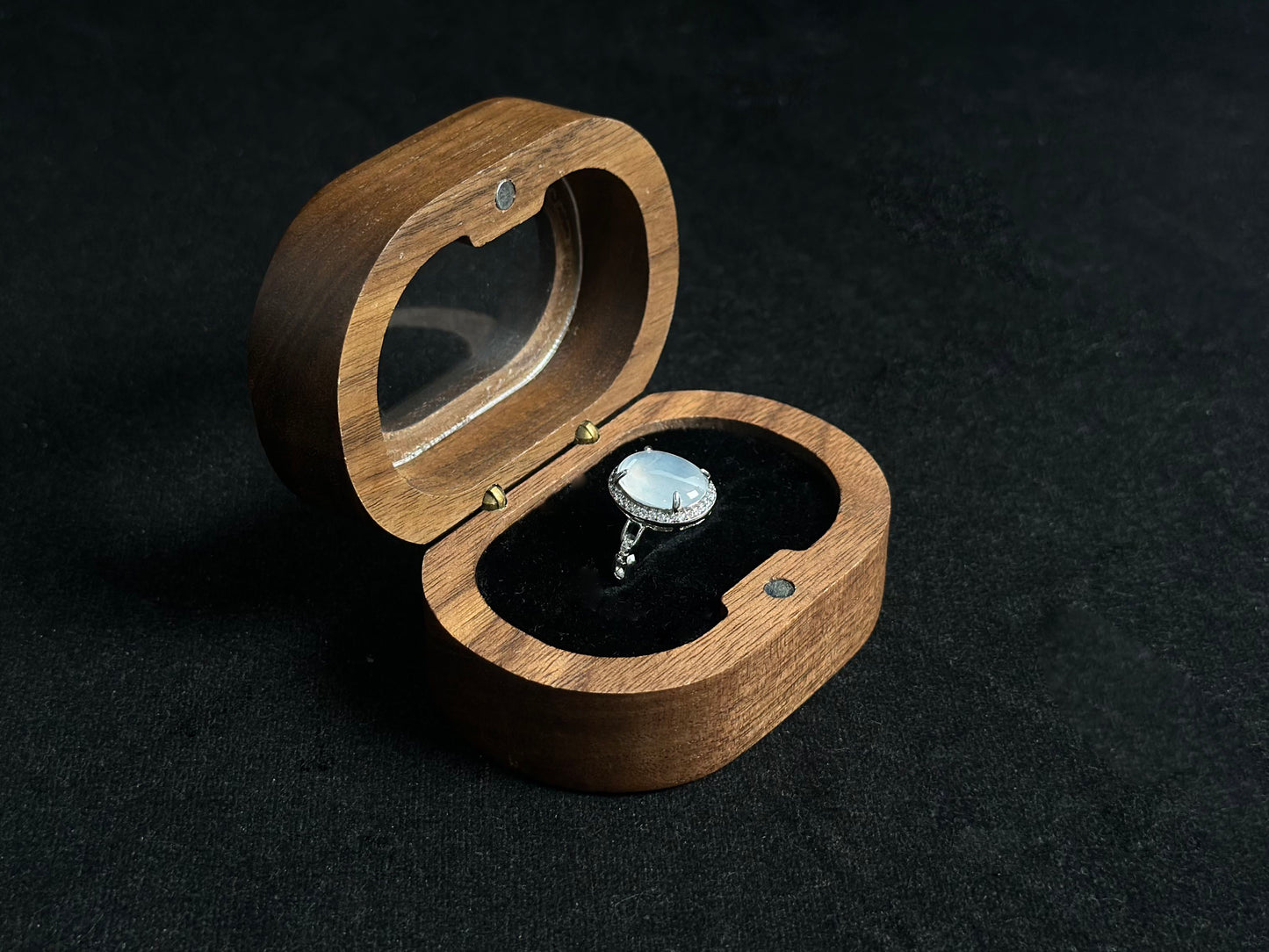 This elegant ring features an ice colored jade bead securely set with channel setting technique.