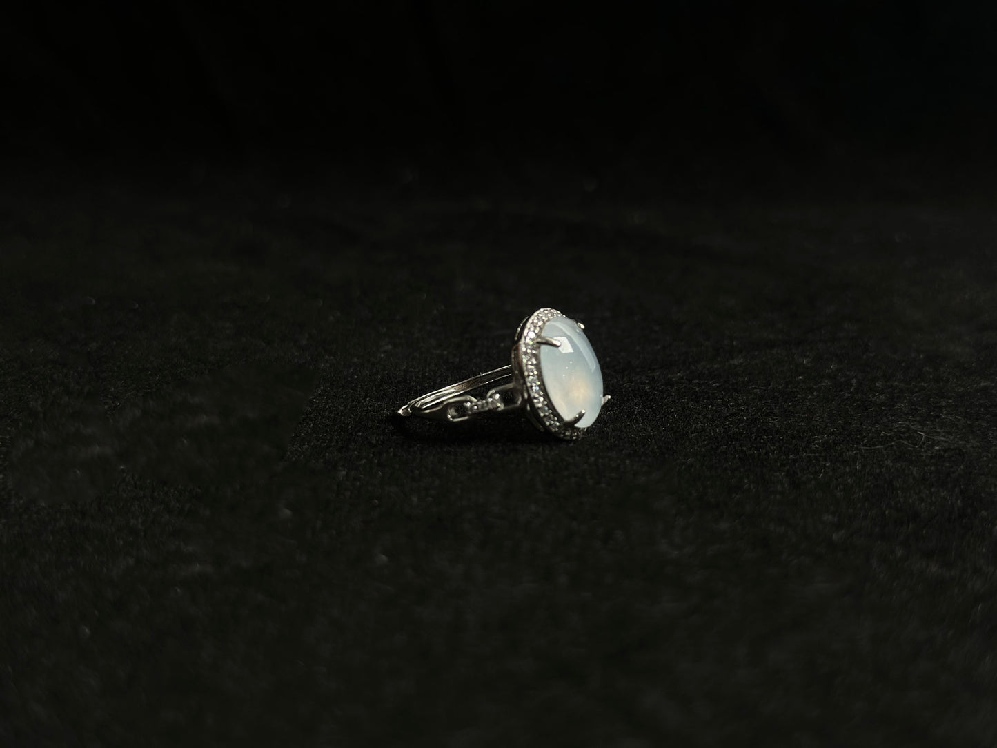 This elegant ring features an ice colored jade bead securely set with channel setting technique.