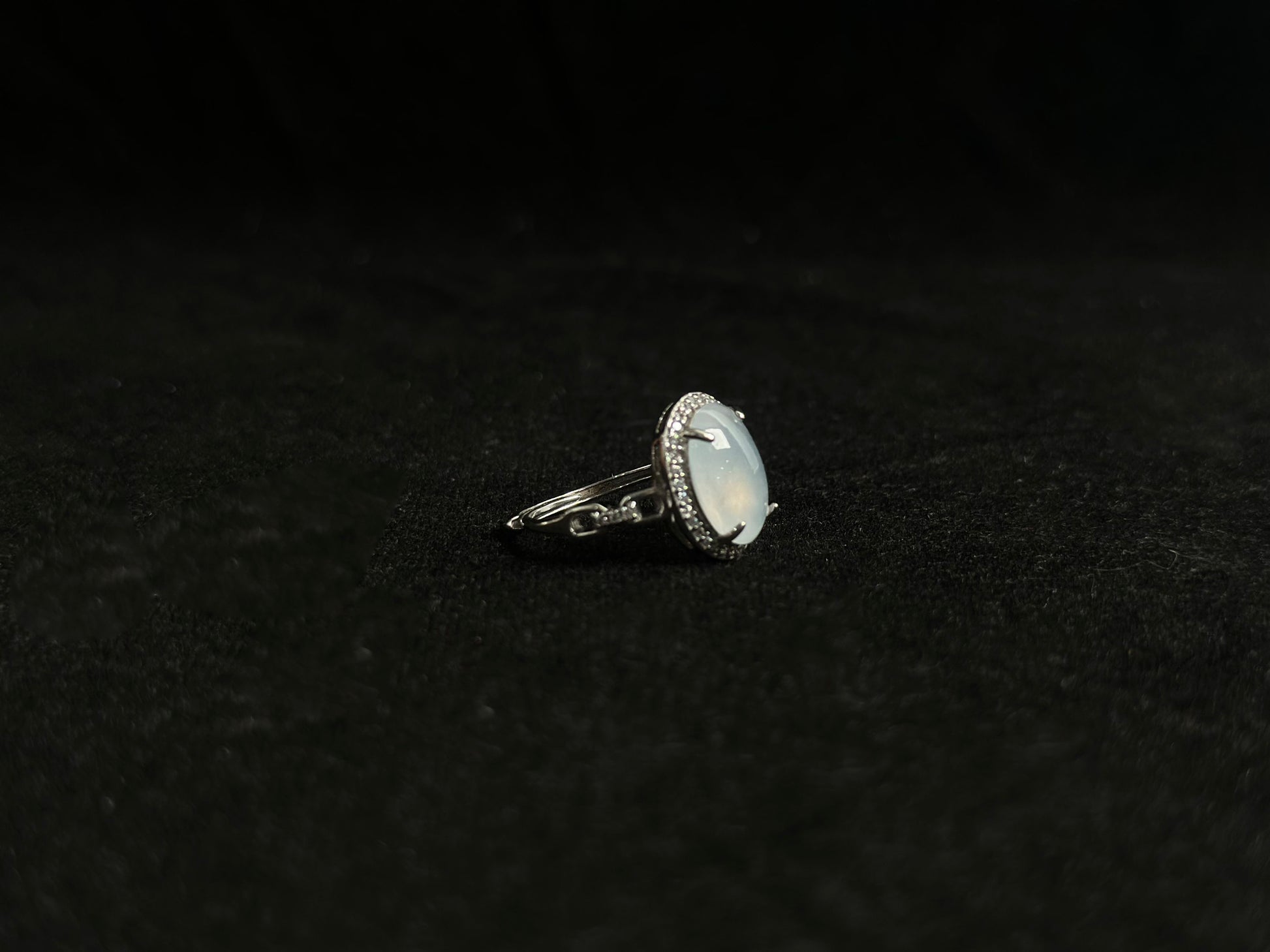 This elegant ring features an ice colored jade bead securely set with channel setting technique.