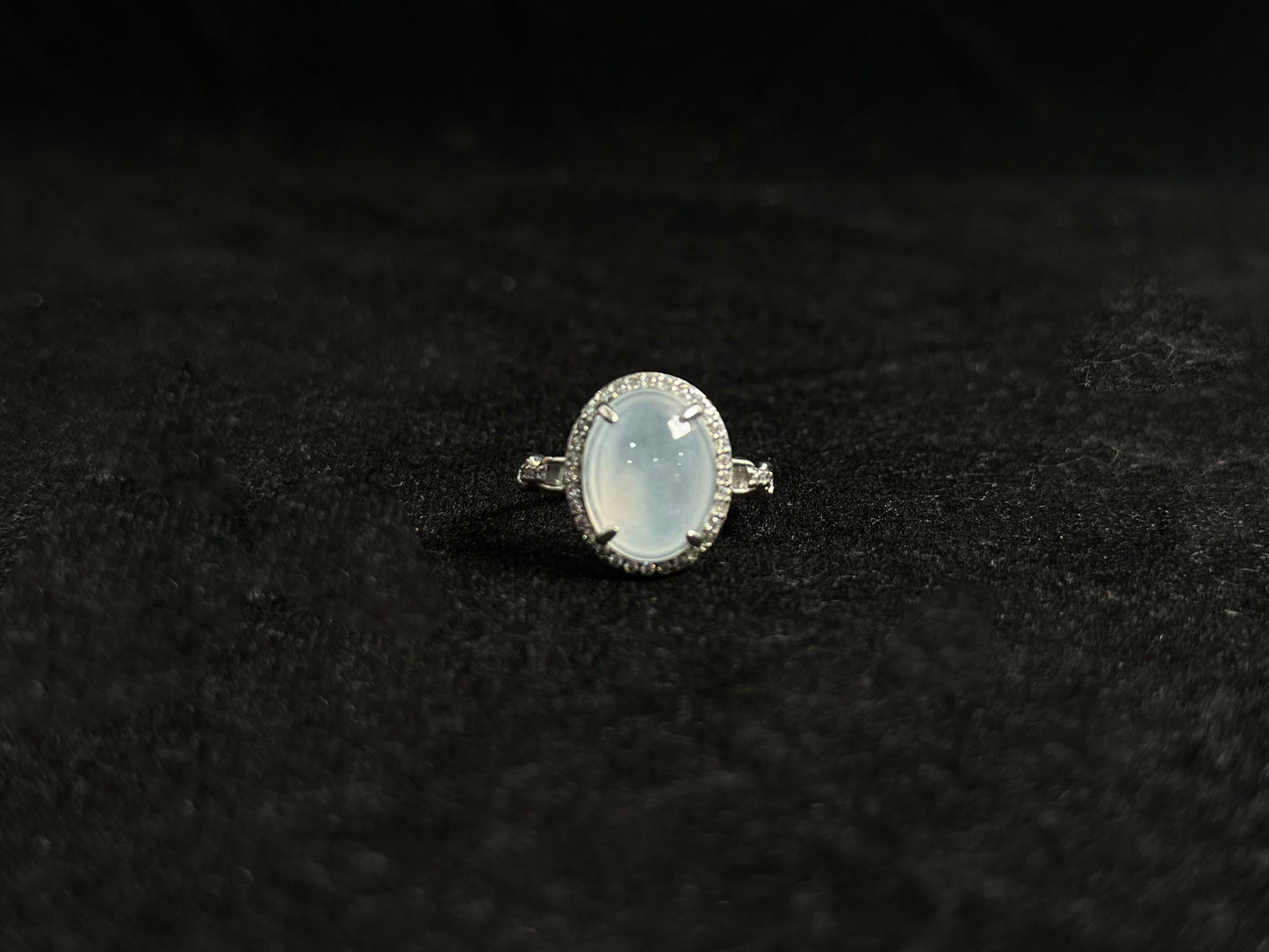 This elegant ring features an ice colored jade bead securely set with channel setting technique.