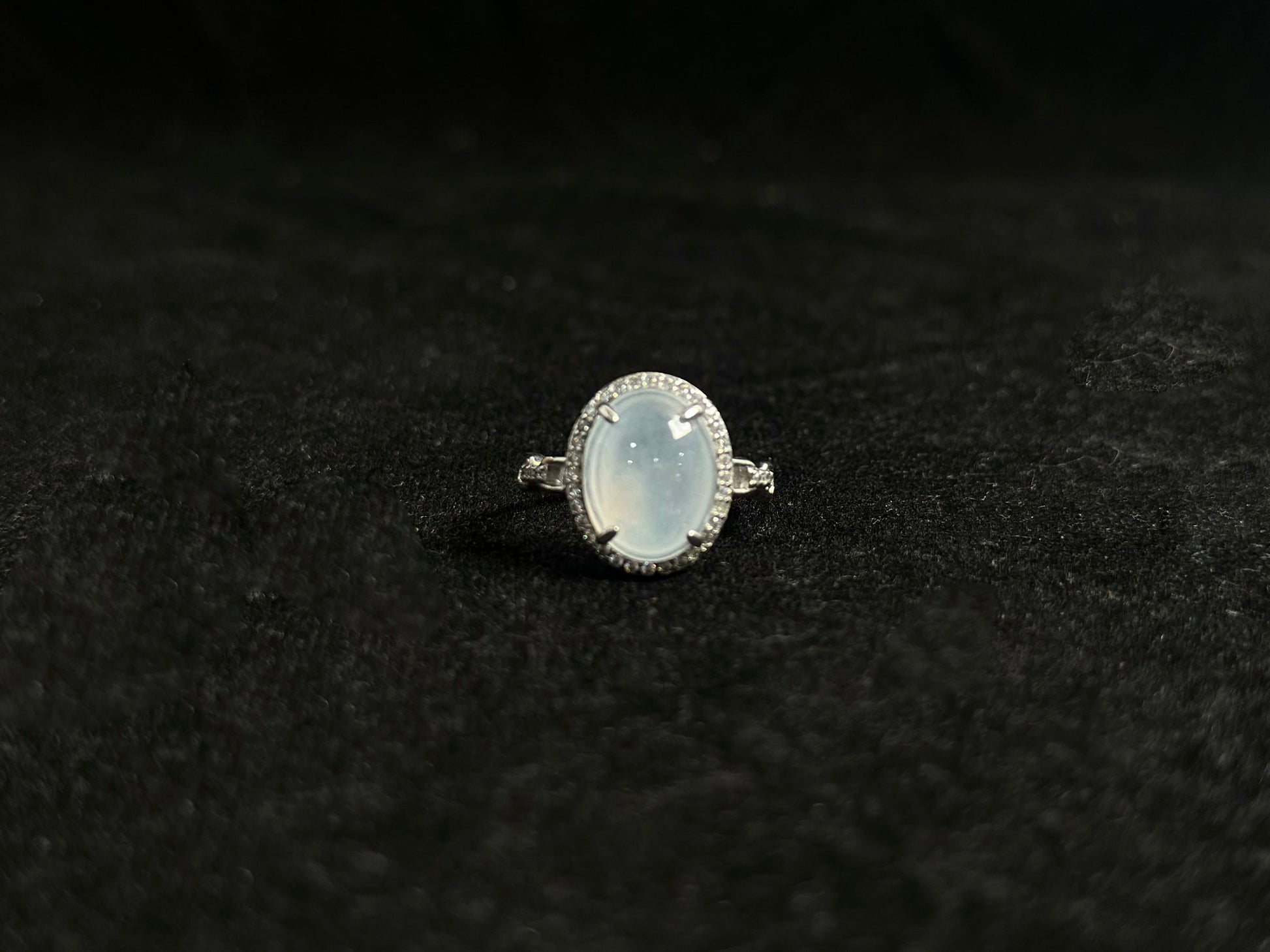 This elegant ring features an ice colored jade bead securely set with channel setting technique.