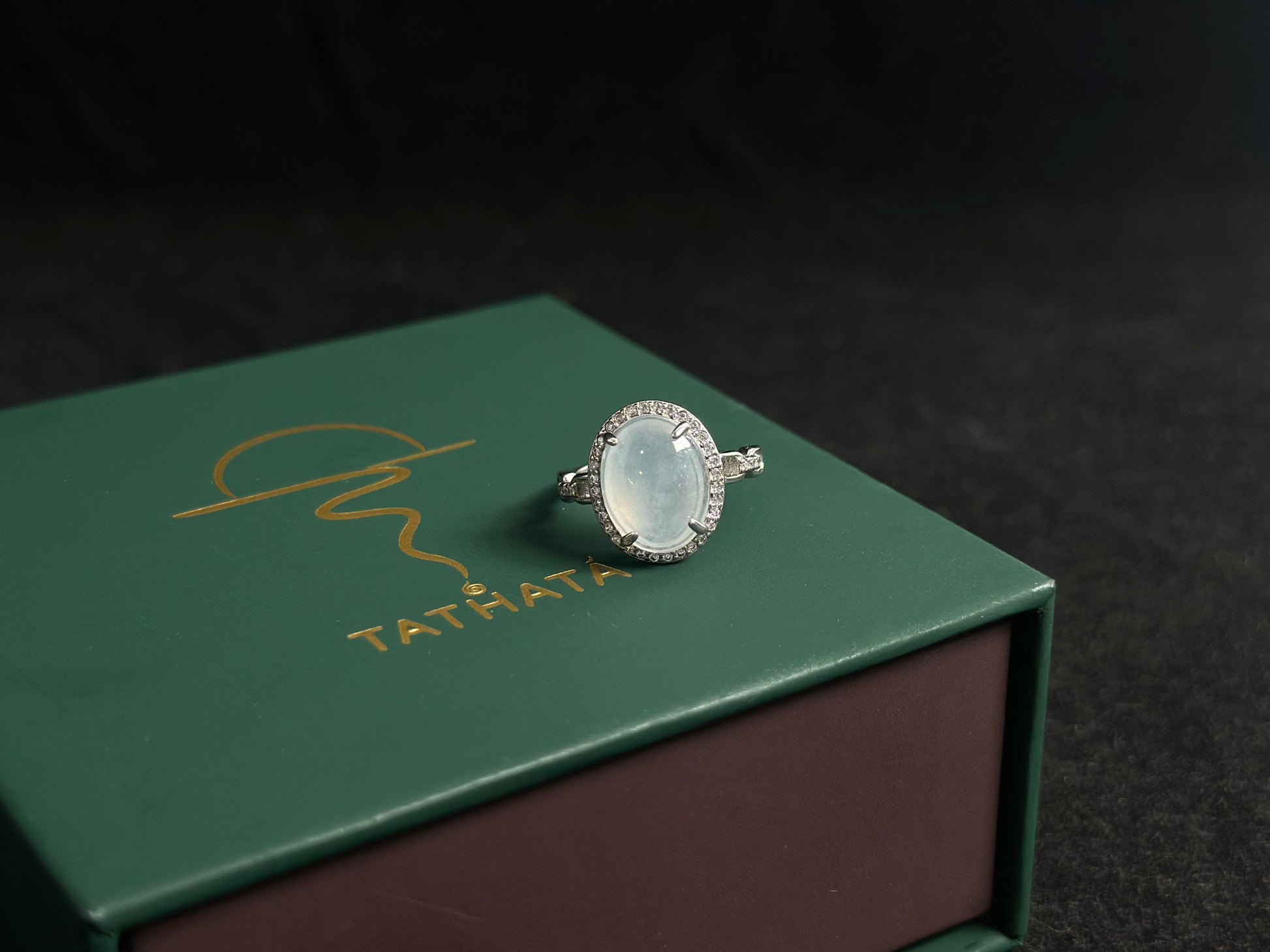 This elegant ring features an ice colored jade bead securely set with channel setting technique.