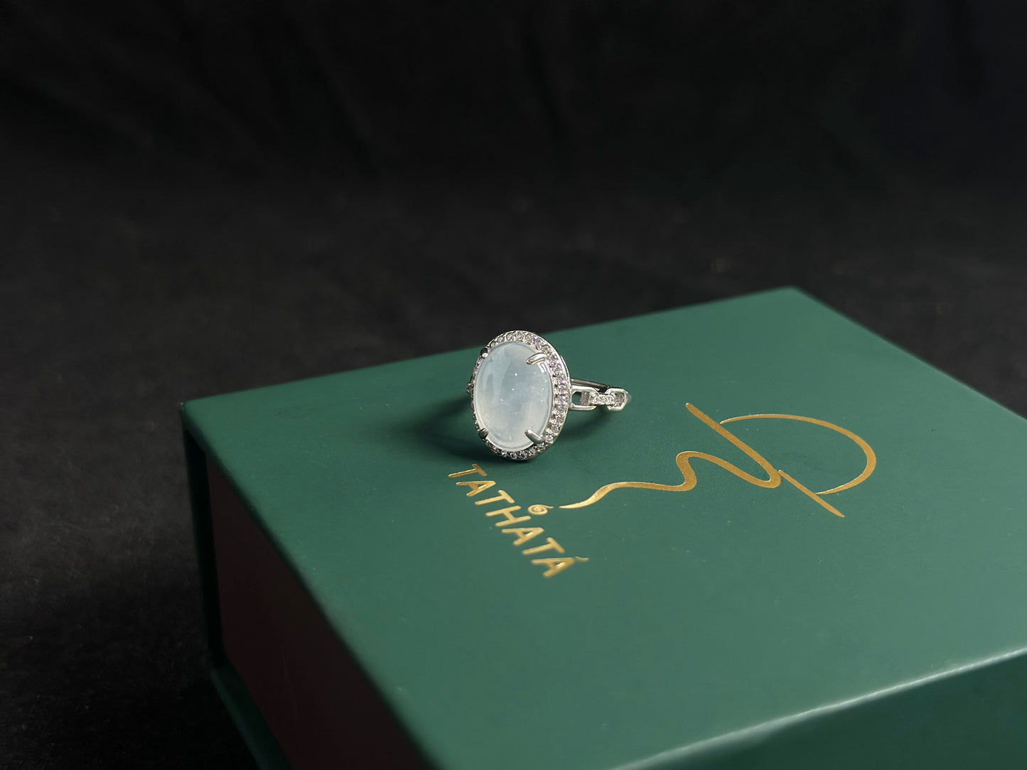 This elegant ring features an ice colored jade bead securely set with channel setting technique.