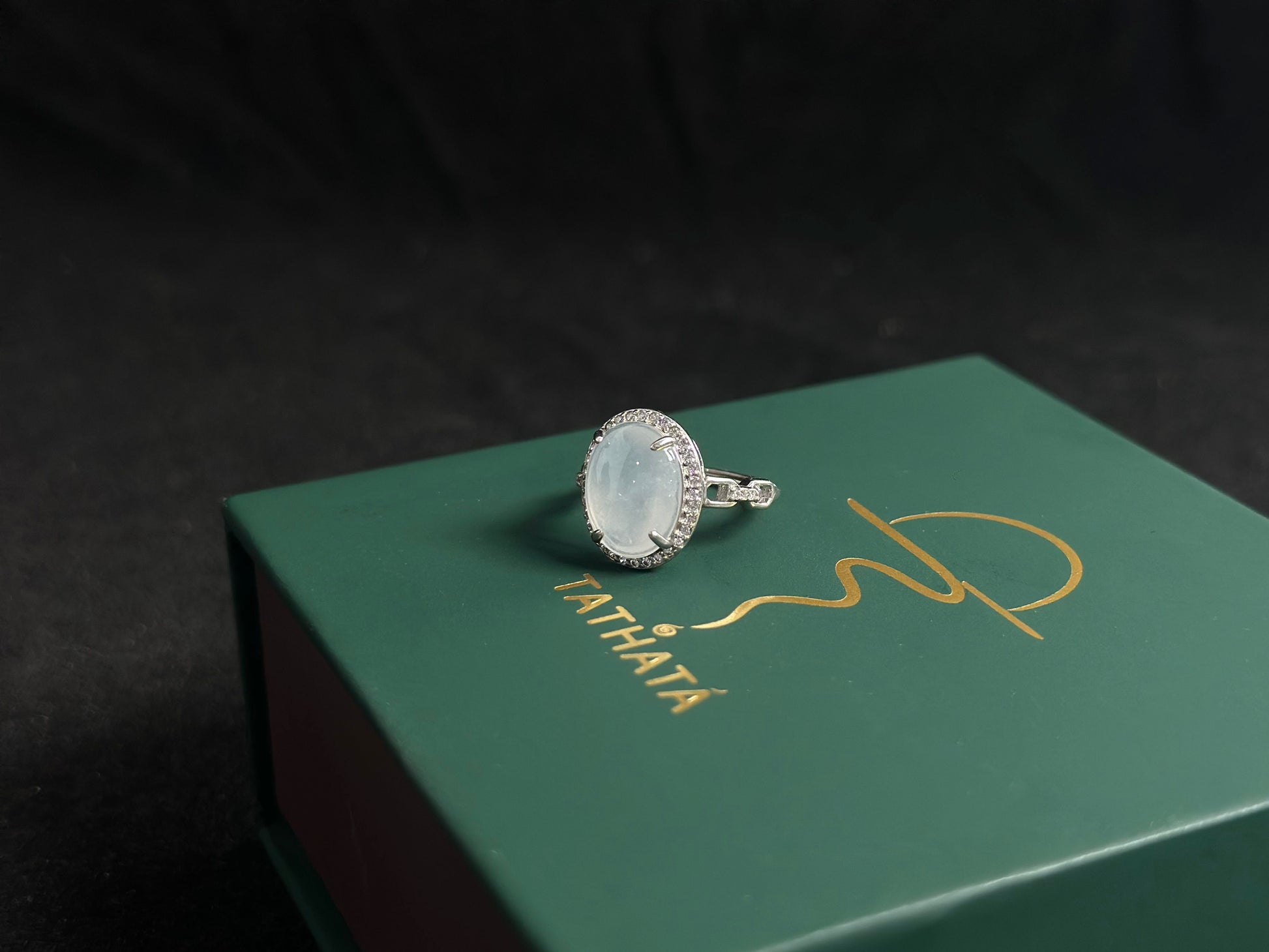 This elegant ring features an ice colored jade bead securely set with channel setting technique.