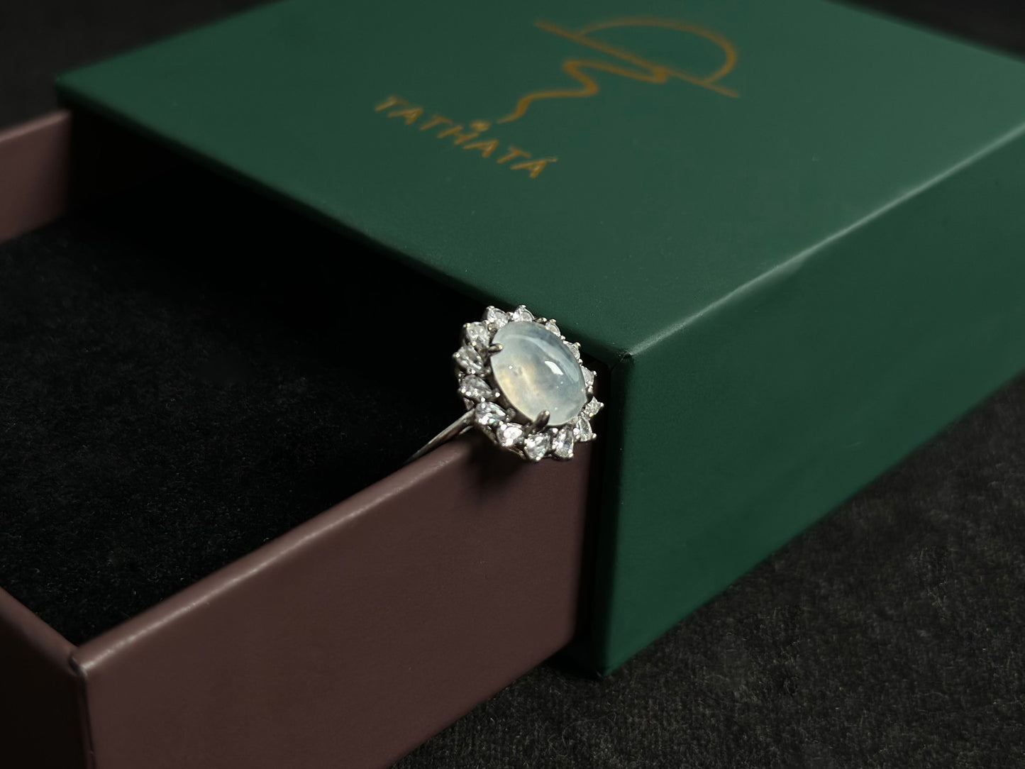 An icy jadeite bead is securely set in this ring using channel setting technique.