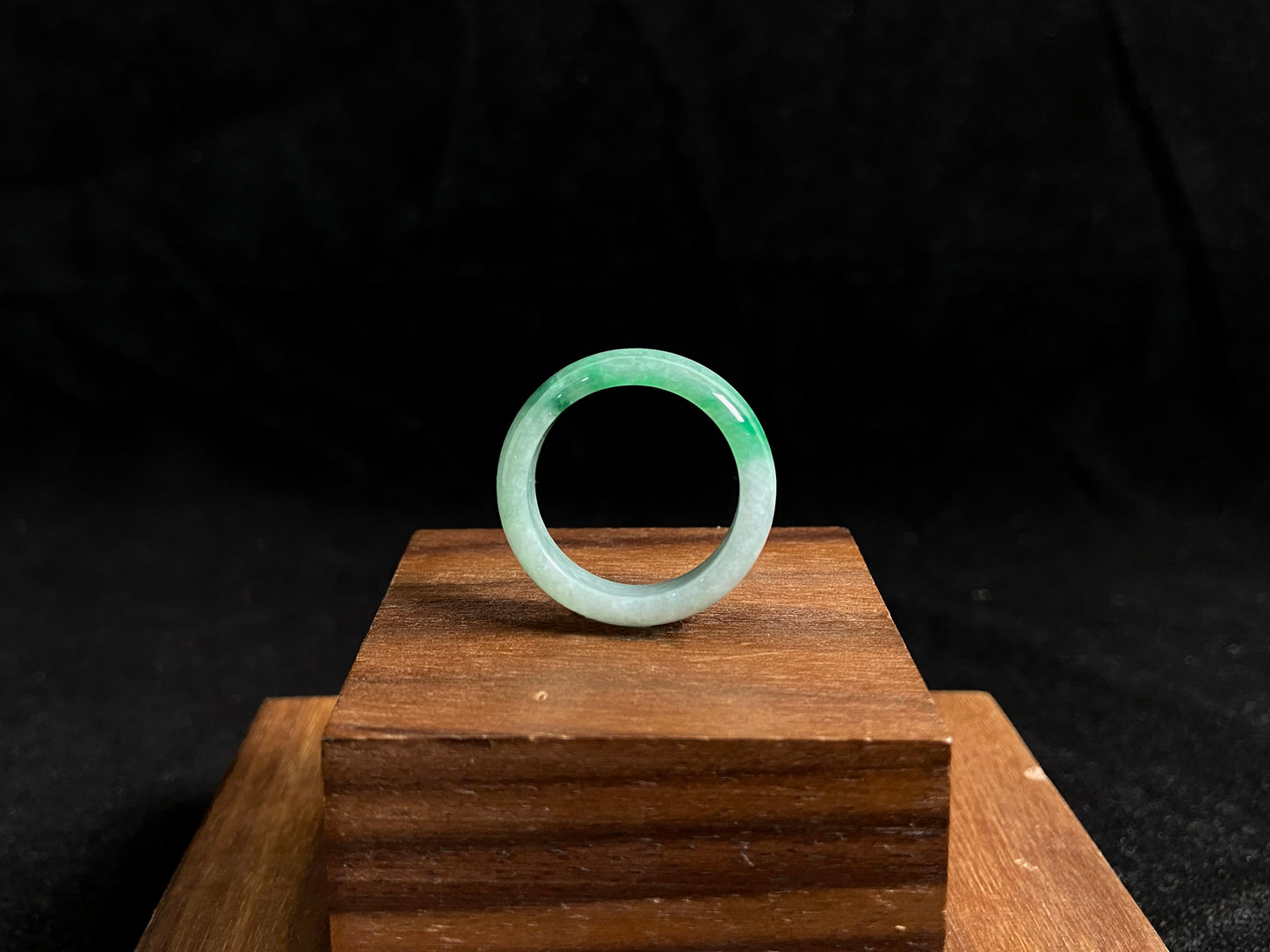 This jade ring features a striking dual tone design with one half in vibrant green and the other in pure white, creating a perfect balance of color contrast.