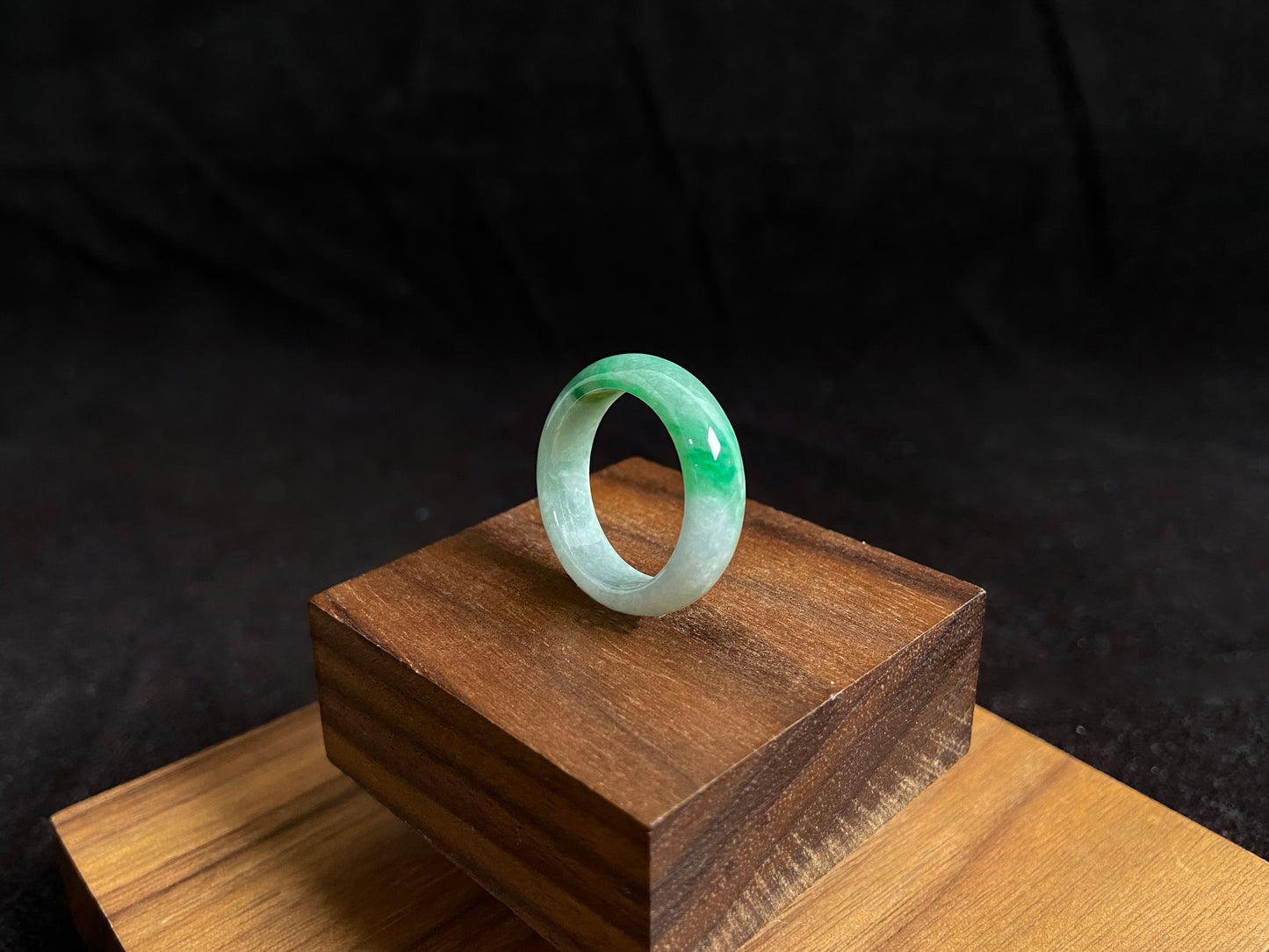 This jade ring features a striking dual tone design with one half in vibrant green and the other in pure white, creating a perfect balance of color contrast.