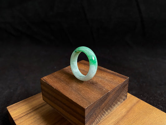 This jade ring features a striking dual tone design with one half in vibrant green and the other in pure white, creating a perfect balance of color contrast.