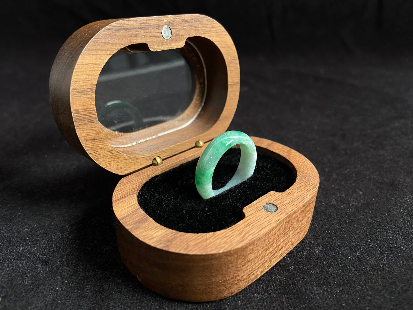 This jade ring features a striking dual tone design with one half in vibrant green and the other in pure white, creating a perfect balance of color contrast.