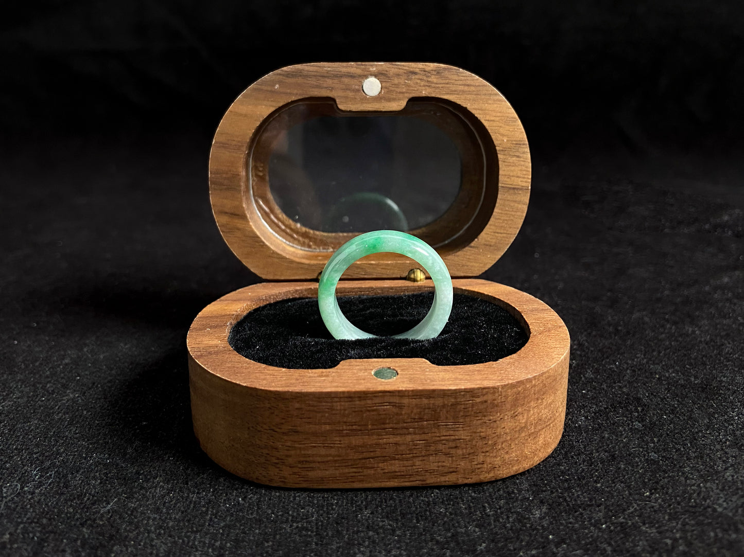 This jade ring features a striking dual tone design with one half in vibrant green and the other in pure white, creating a perfect balance of color contrast.