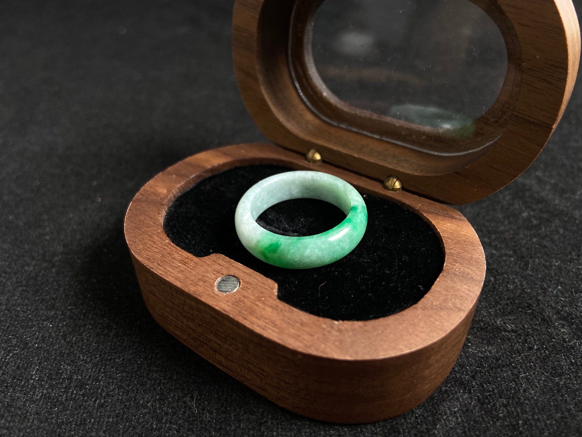 This jade ring features a striking dual tone design with one half in vibrant green and the other in pure white, creating a perfect balance of color contrast.