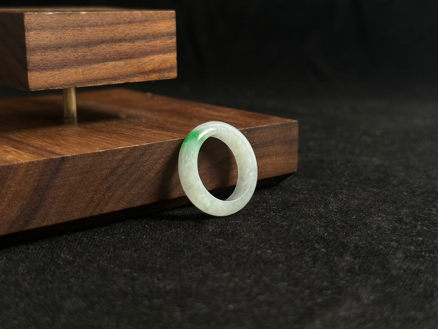 An ice colored jadeite ring adorned with a delicate green accent.