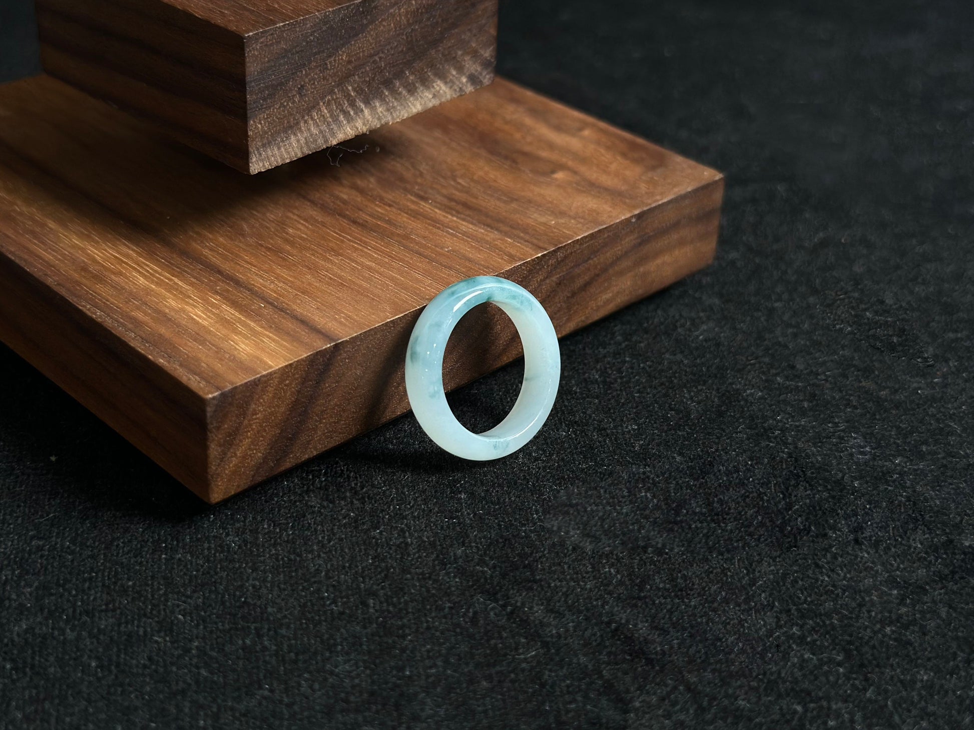 This exquisite jade ring features a transparent base with elegant deep green inclusions floating within the crystal clear stone.