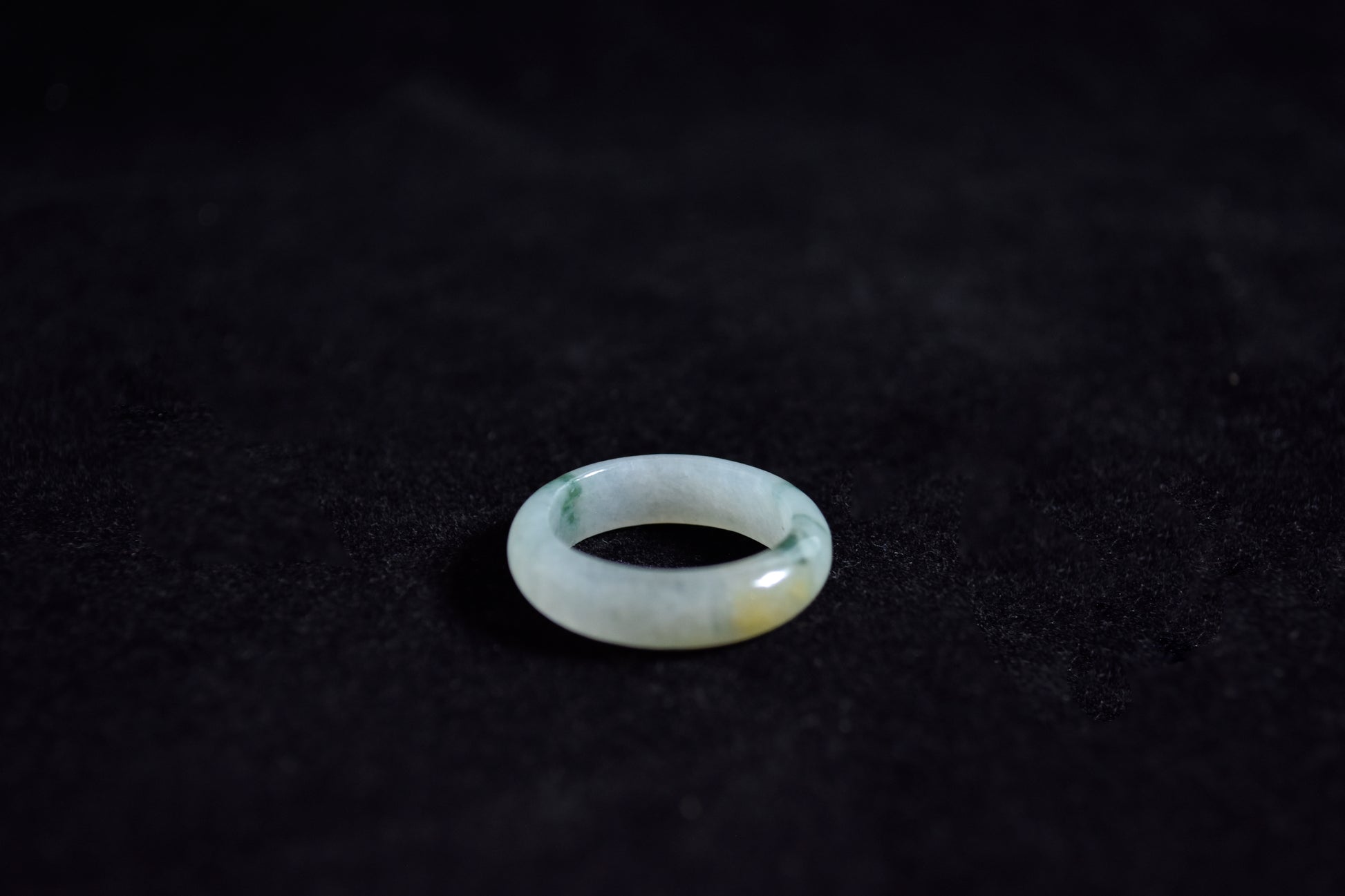 Clear gemstone ring on a dark textured surface