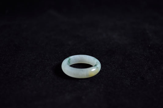 Clear gemstone ring on a dark textured surface