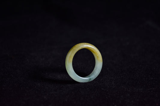 huang fei jade ring on a black background